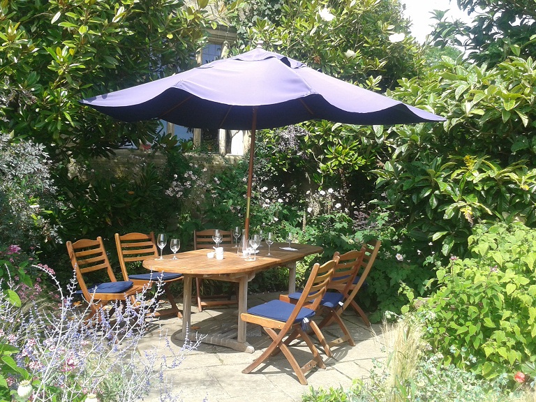 Outdoor dining in the gardens at Gravetye Manor